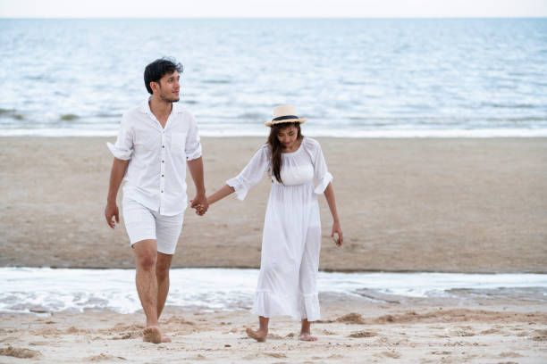 istock Happy young couple walk on the beach on honeymoon. 1037182962