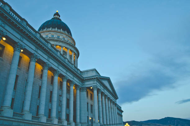 A grand view of the utah state capitol in the evening setting sunlight under the clouds.