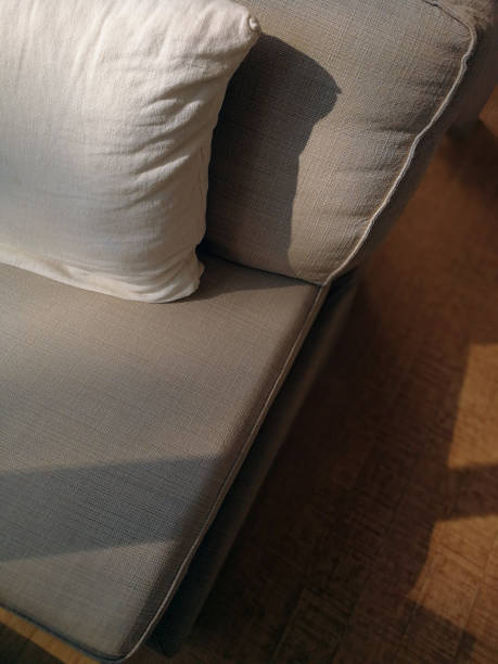 istock Close up of a fabric sofa with styled cushions and throw 1037211456