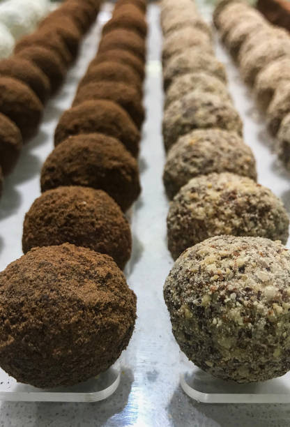 istock Rows of chocolate truffles isolated on white blackground 1037219296