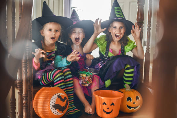 istock Laughing children in witches costumes. 1037219748