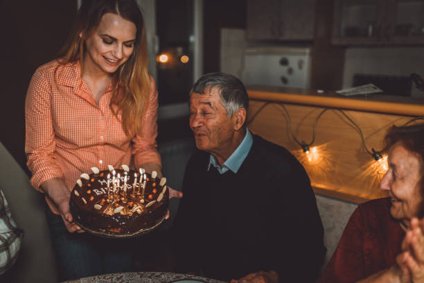 istock Grandfather blowing candles for his birthday 1037226442