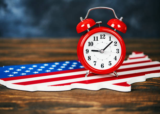 istock Bright red clock with chalkboard background and USA map 1037249128