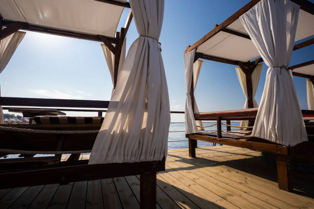istock Beach beds for relaxation on the pier in the sea 1037260020