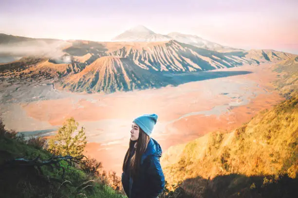 Traveler woman with sunrise at volcano Mt.Bromo (Gunung Bromo) Kingkong hill East Java,Indonesia