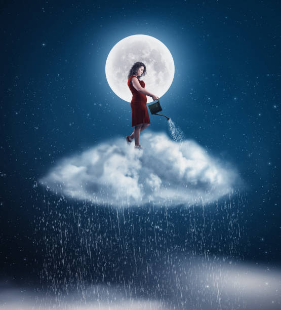 istock Young woman on a cloud using sprinkle and makes rain in the night. 1037268904
