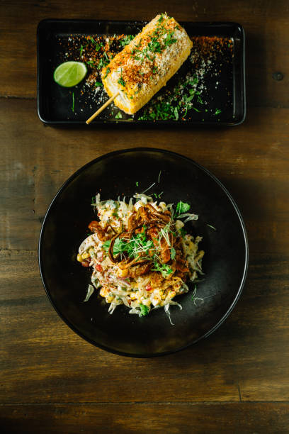 istock Mexican style pomelo salad topping with deep fried soft shell crab in black plate. 1037283988