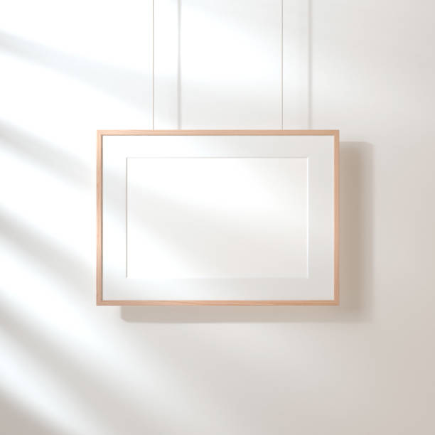istock Horizontal poster with wooden frame mockup hanging on the wall with shadows 1037287584