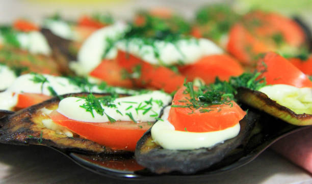 istock Fried eggplants and fresh tomato with souce and herbs 1037287762