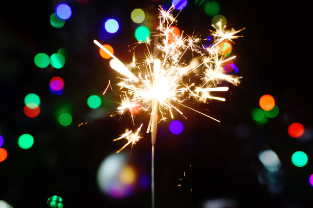 istock Bright sparkler with Christmas tree on background 1037308530