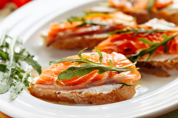 istock Whole grain bread with avocado paste and salmon decorated with arugula 1037309672
