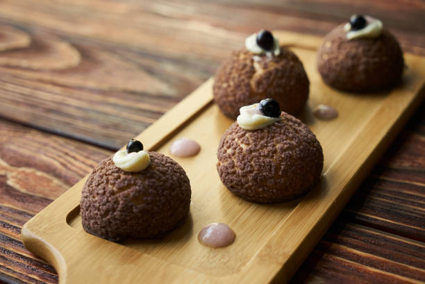 istock Delicious White chocolate profiteroles with peach violet 1037330986