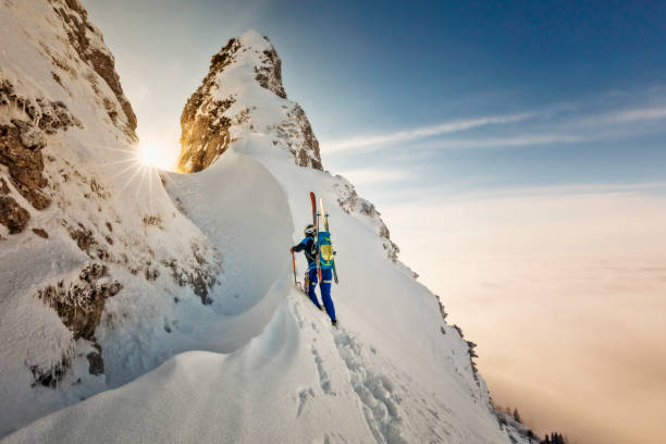 ski mountaineer with crampons and ice ax- freerider at the way to summit - alps - skiing winter snow mountain imagens e fotografias de stock