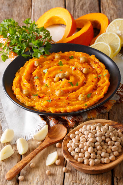 istock Middle Eastern food: pumpkin hummus with ingredients close-up. vertical 1037337920