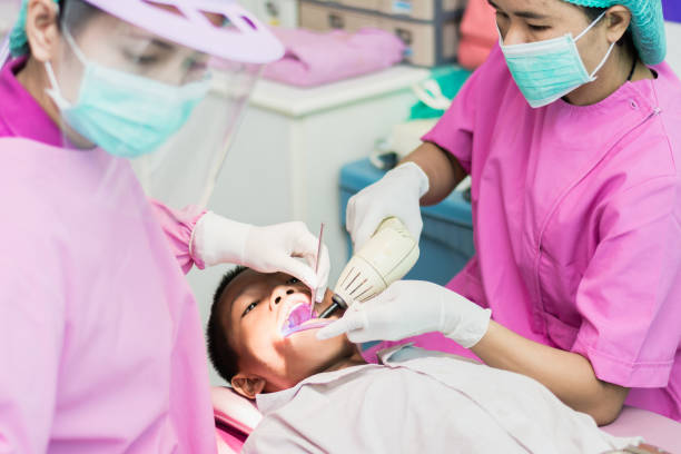 istock Satisfied dentist patient showing his tooth at sanitation. 1037339686