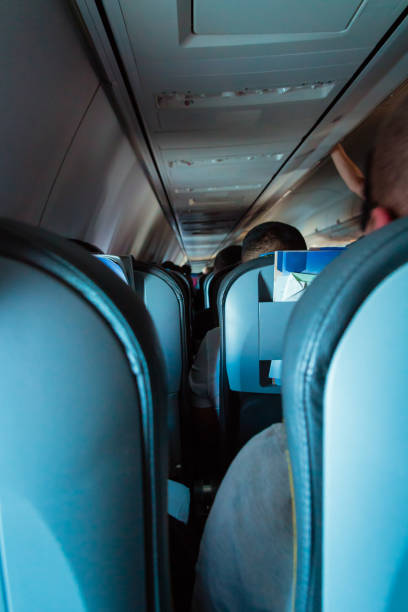 istock Interior of passenger airplane with people on seats 1037339942