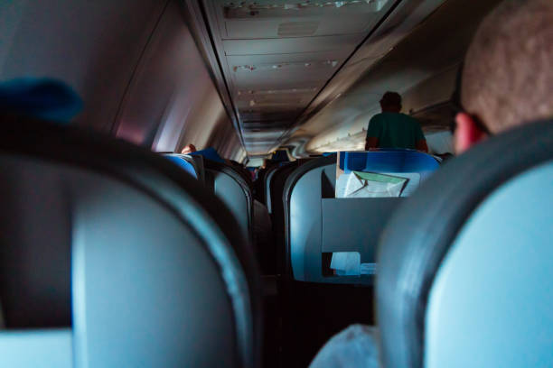 istock Interior of passenger airplane with people on seats 1037344320
