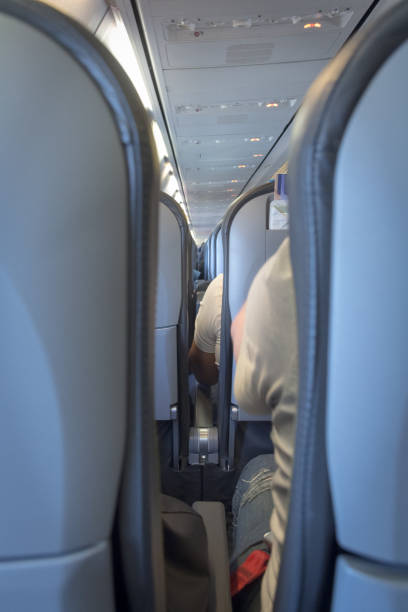 istock Interior of passenger airplane with people on seats 1037344384
