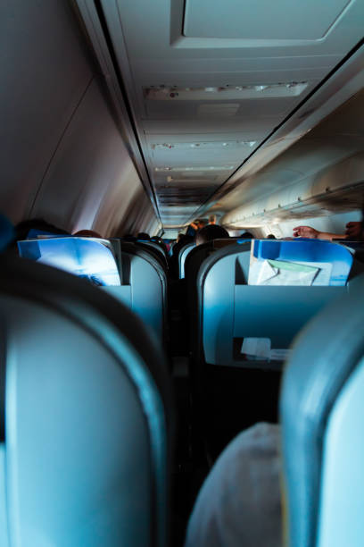 istock Interior of passenger airplane with people on seats 1037344498