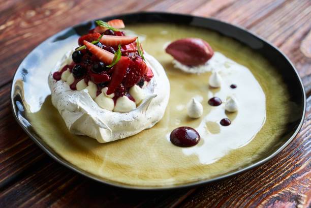 istock Pavlova Cake with Whipped Cream, Raspberry Jam and Assorted Frui 1037348198