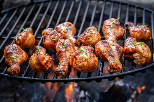 istock Hot chicken leg on grill with herbs and spices 1037354608