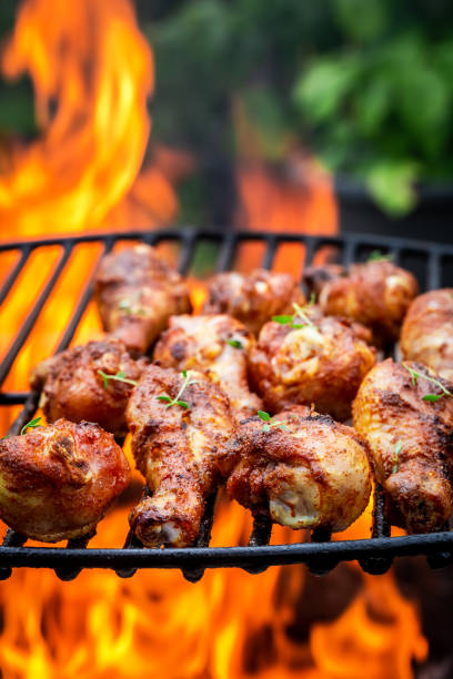 istock Tasty chicken leg on grill with flames 1037354692