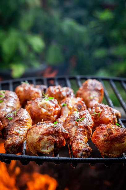 istock Spicy chicken leg on grill with herbs and spices 1037356742