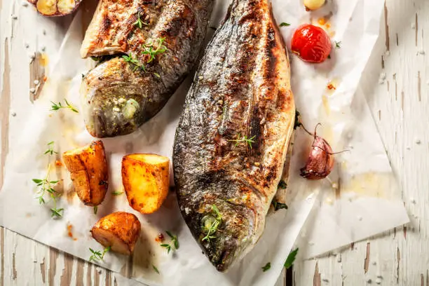 Tasty potatoes and seabream with cherry tomatoes and thyme