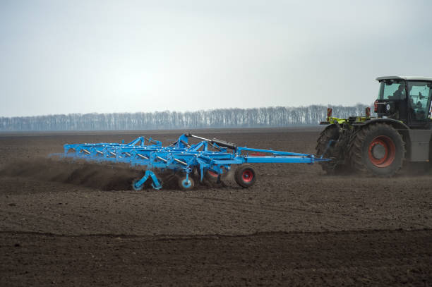 istock Farmer in tractor preparing land with seedbed cultivator 1037370530
