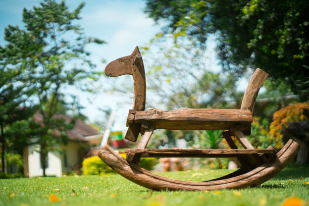 Wooden Rocking Horse on wooden background. Colorful horizontal photo of children toy