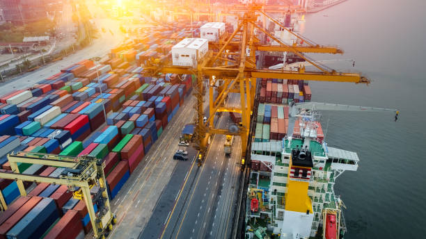 istock Logistics and transportation of Container Cargo ship and Cargo plane with working crane bridge in shipyard at sunrise, logistic import export and transport industry background 1037378616
