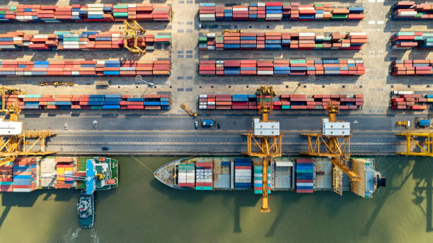istock Logistics and transportation of Container Cargo ship and Cargo plane with working crane bridge in shipyard at sunrise, logistic import export and transport industry background 1037378646