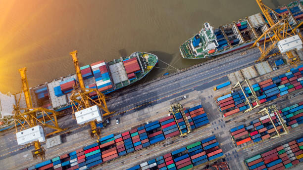 istock Logistics and transportation of Container Cargo ship and Cargo plane with working crane bridge in shipyard at sunrise, logistic import export and transport industry background 1037379638