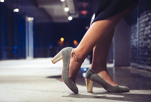 Waiting for entrance to nightclub with high heel shoes close-up
