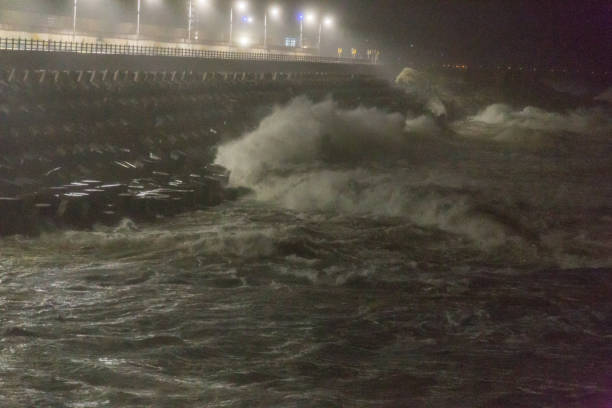 istock Big rough waves creashing into coastline during typhoon storm 1037390816