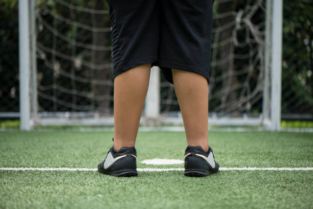 istock Legs On Soccer Field 1037396610