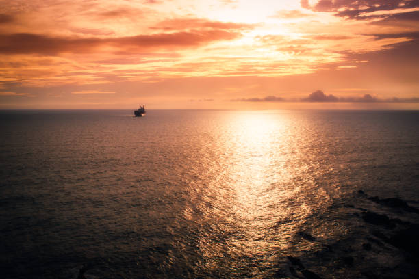 istock Sunset at the sea with a ship in distant plane. 1037397548