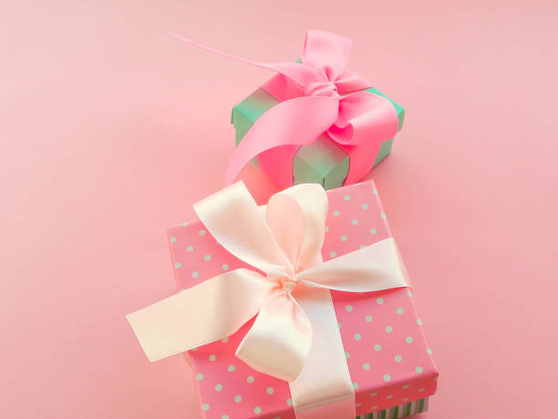 istock Pink Christmas gift with ribbon, on pink background 1037400620