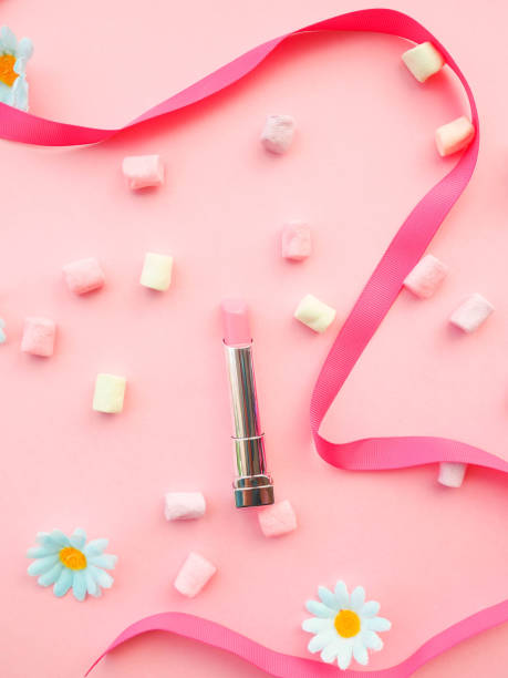 istock Many cosmetics on pink background, brush, lipstick, ribbon 1037401080