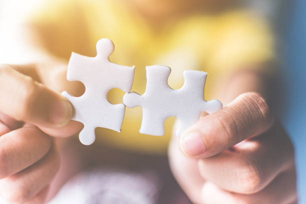 istock Strategic management and business solutions for success, Hand connecting jigsaw puzzle 1037401098