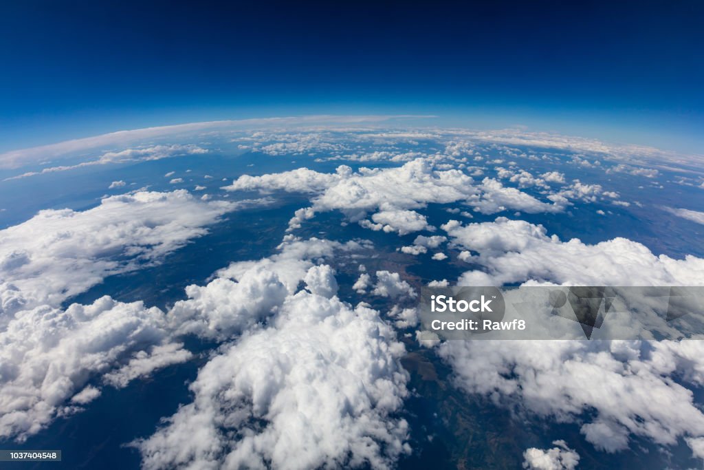 Curvature of planet earth. Aerial shot. Blue sky and clouds Curvature of planet earth. Aerial shot. Blue sky and clouds over land Globe - Navigational Equipment Stock Photo