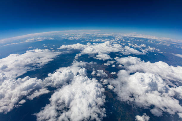 Curvature of planet earth. Aerial shot. Blue sky and clouds Curvature of planet earth. Aerial shot. Blue sky and clouds over land blue world stock pictures, royalty-free photos & images