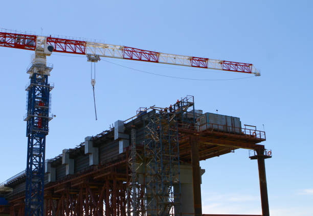 istock industrial image of bridge construction - tall crane on the construction site 1037404616