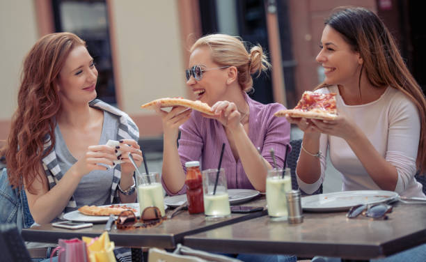 istock Friends eating pizza in cafe 1037410970