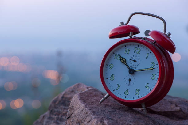 istock Red alarm clock at sunrise on the mountain 1037416660