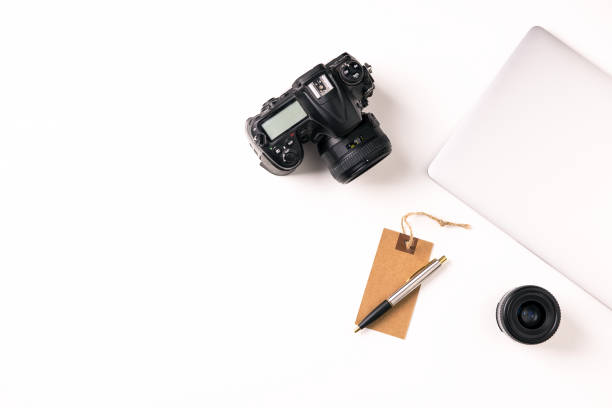 istock Station photographer with notebook, camera and lenses 1037416996