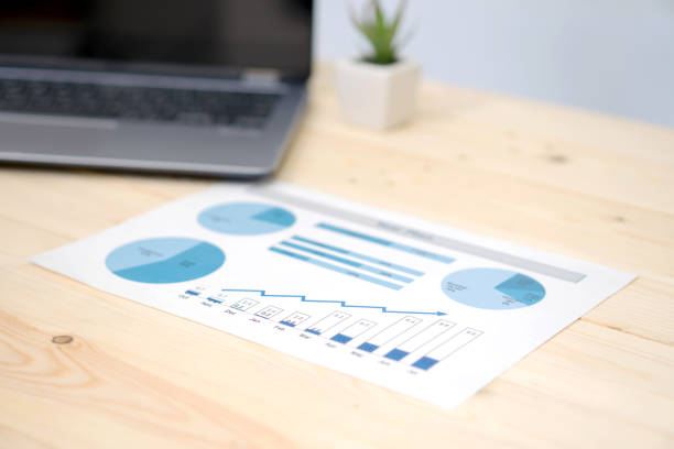 istock laptop and financial graph on white paper on working table 1037432654