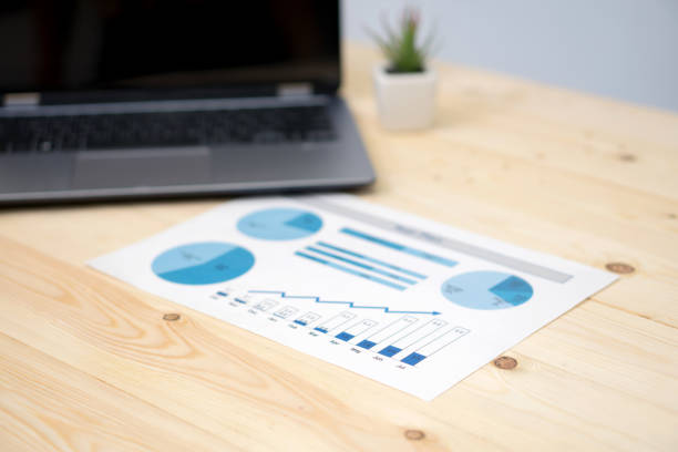 istock laptop and financial graph on white paper on working table 1037432708