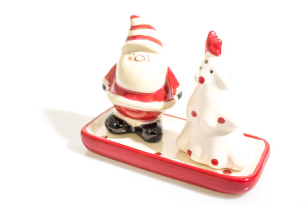 istock Christmas decorations, santa claus and a ceramic tree isolated in a white background composition 1037437132