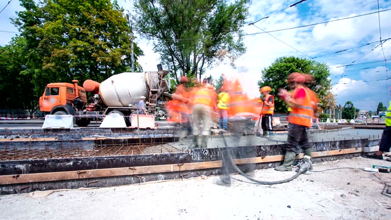 Concrete works for road maintenance construction with many workers and mixer timelapse hyperlapse